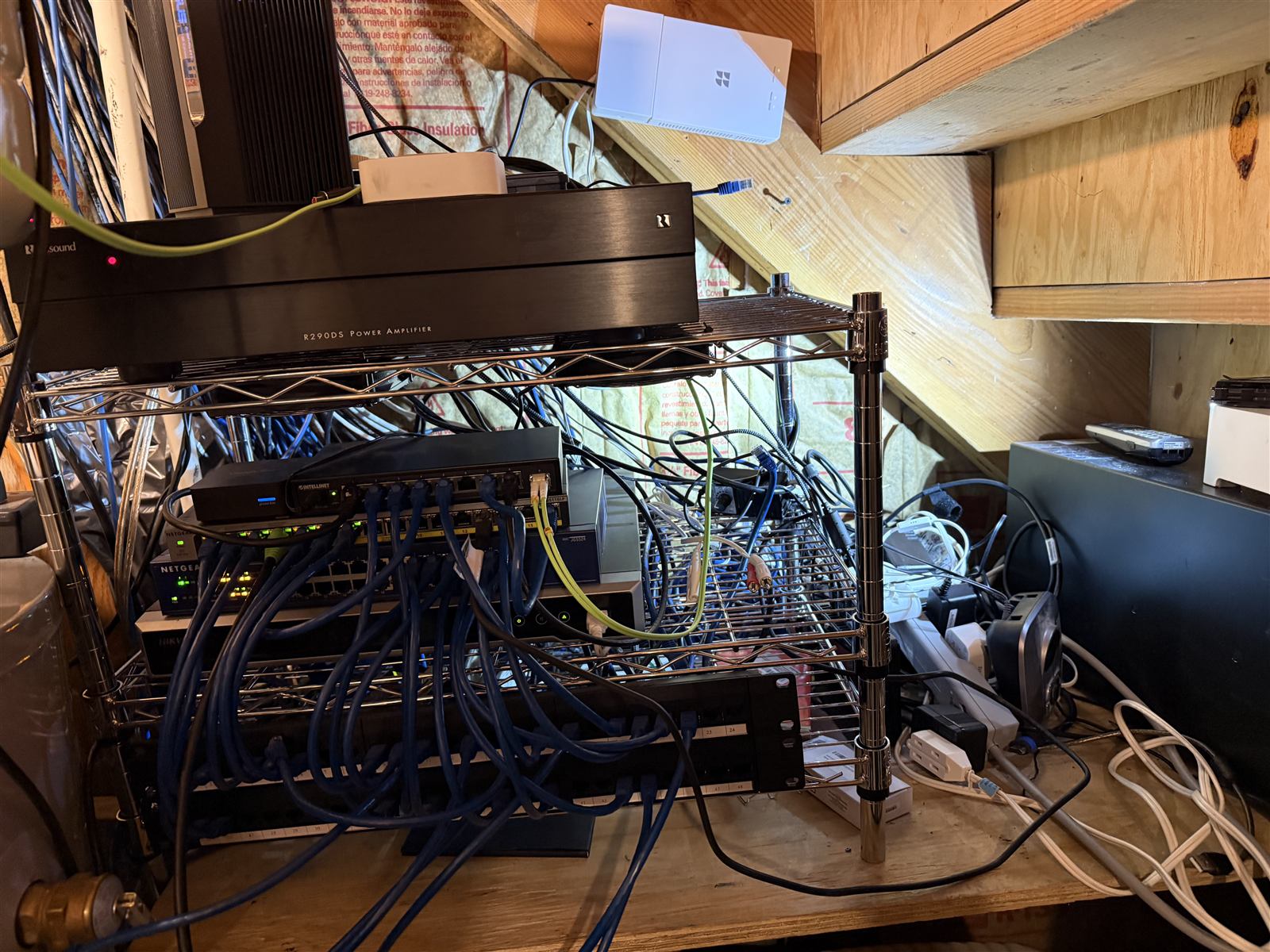 Before: network switches on a wire shelf with tangled unlabeled cables running in every direction